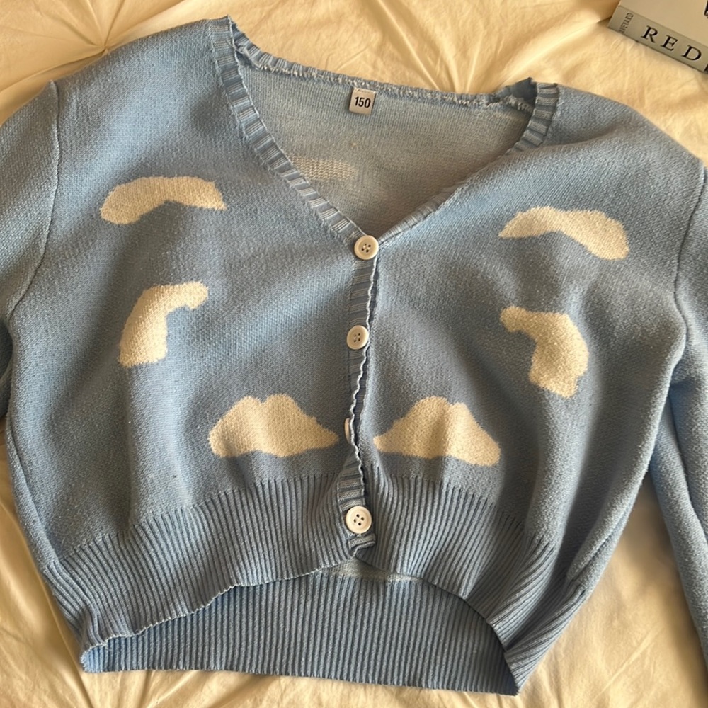 a blue sweater with white clouds long-sleeve